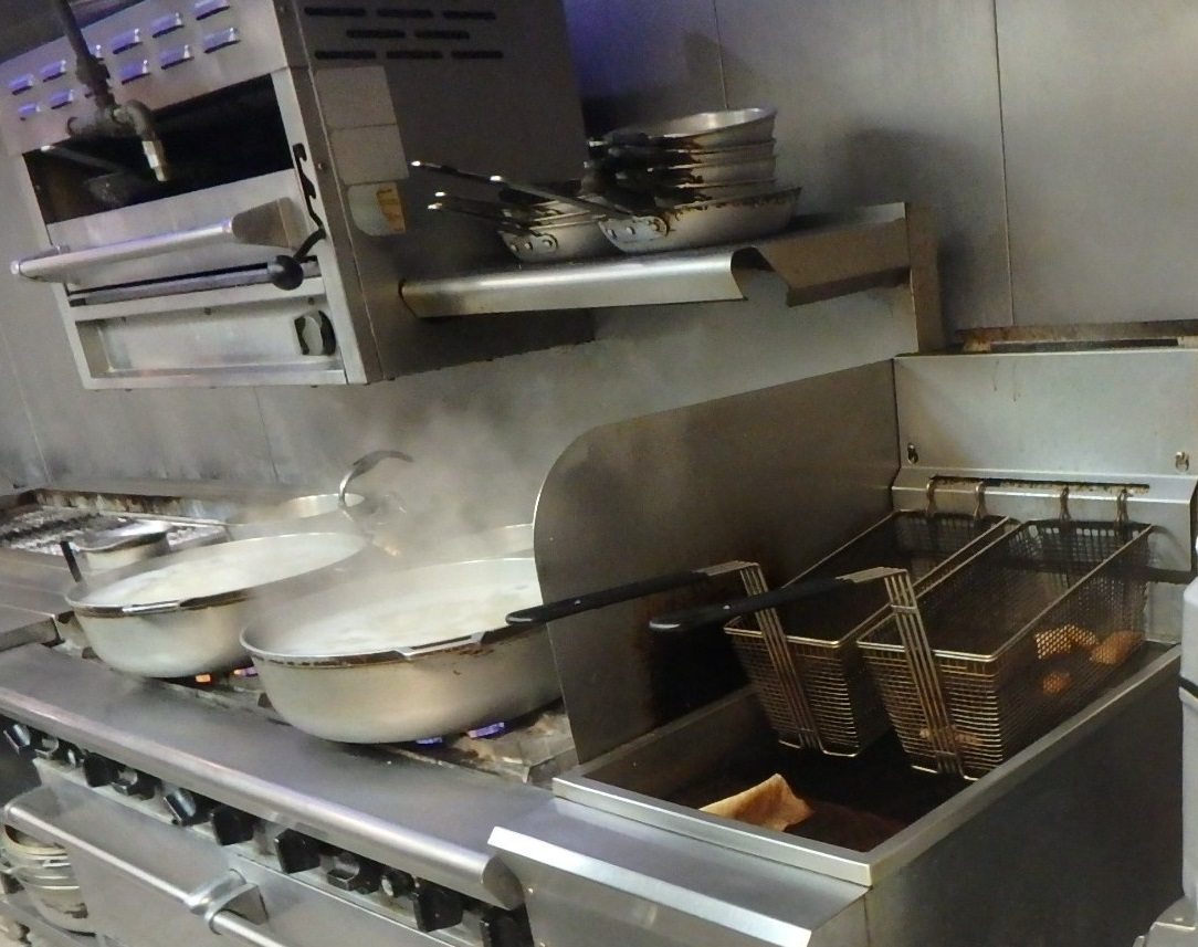Why are adequate clearances between deep fat fryers and open flame